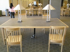 [Tables in the Library. Note the electricity and network drops.]